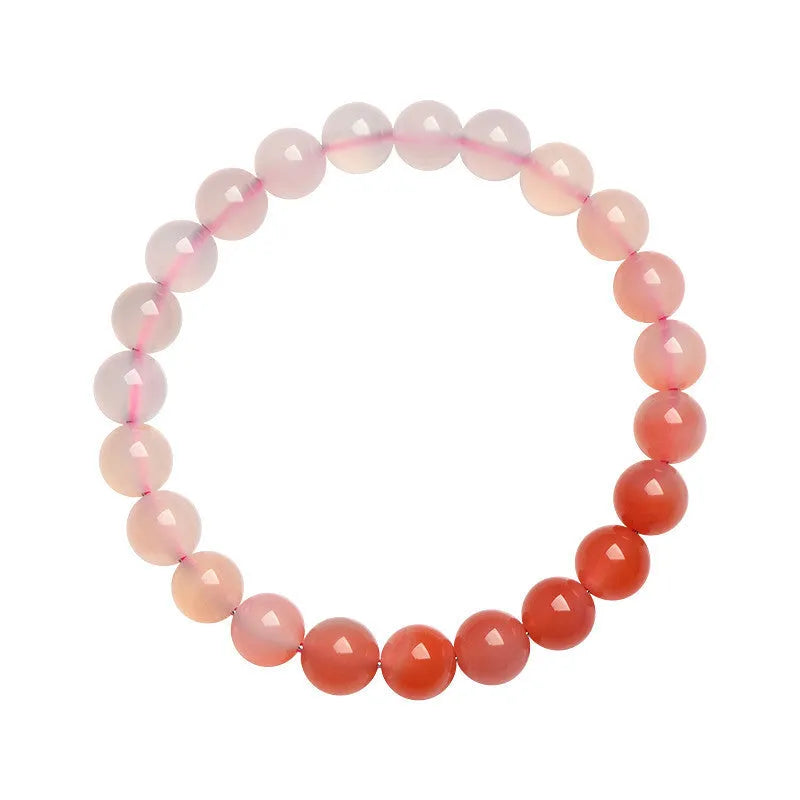 A gradient colour agate bead bracelet on a wrist, showing natural stone banding.