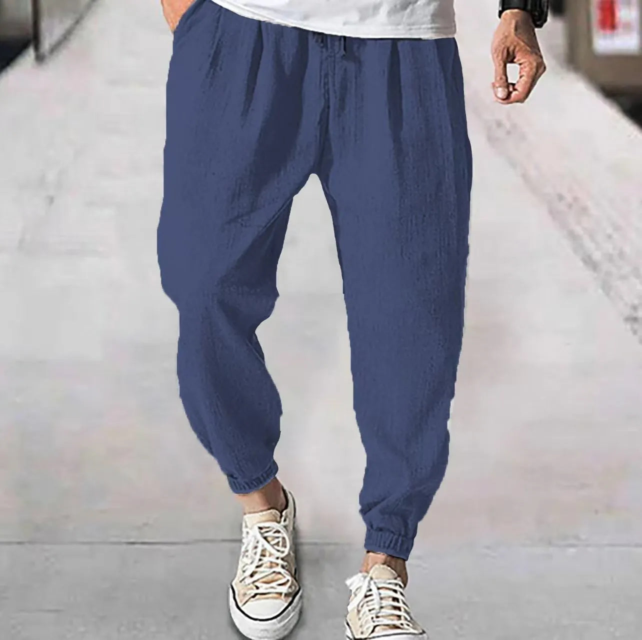 Men's cotton ankle banded trousers in light green colour showing loose fit and summer casual styling