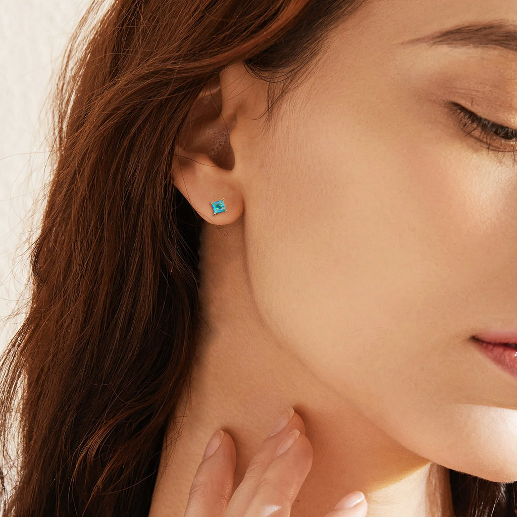Gold-plated drop earrings with colourful cubic zirconia stones on a copper base.