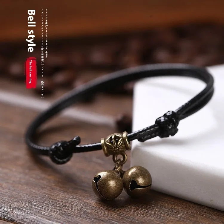 Adjustable nylon dog halter collar with brass bell shown in black rope colour fitting small dog