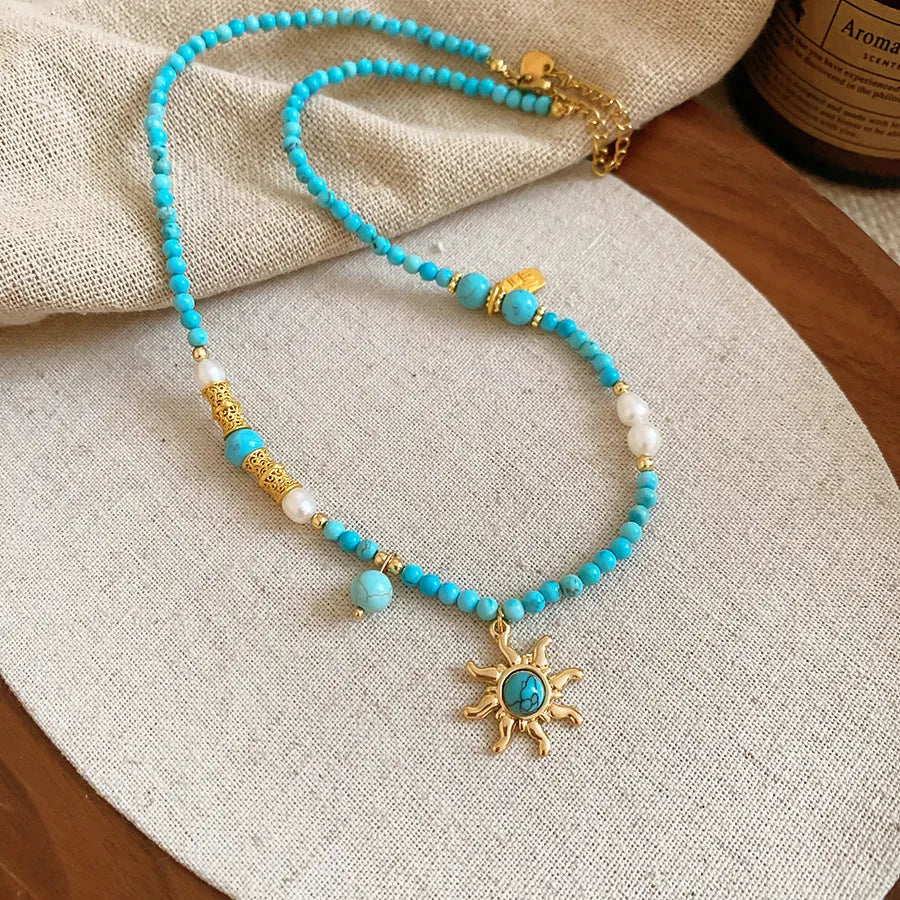 Freshwater pearl sun necklace on clavicle chain in court style, blue-sun colour option.