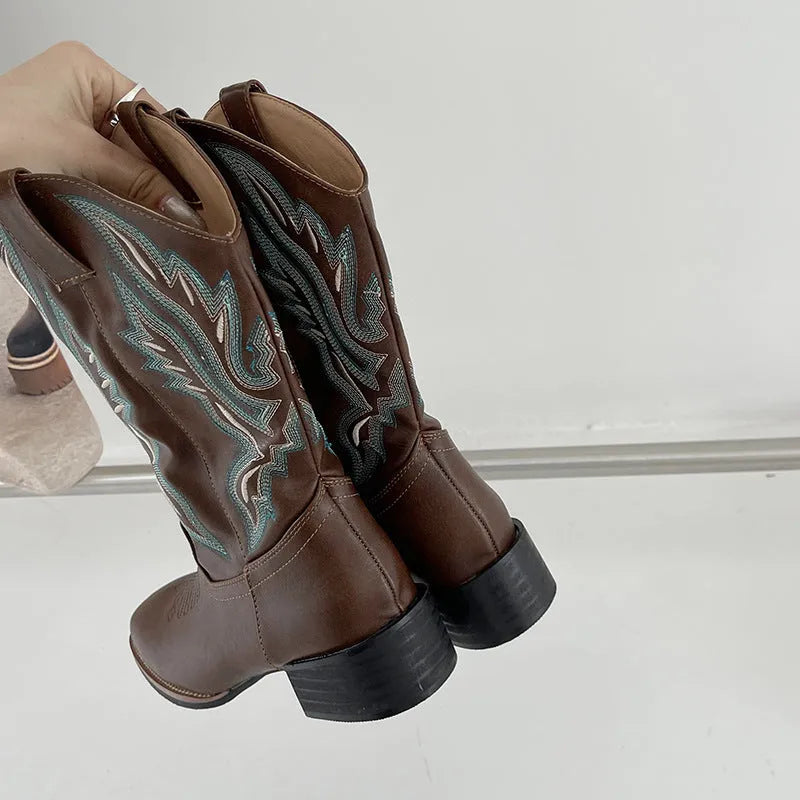 Brown women's Martin boots with embroidered toe cap and mid-calf height.