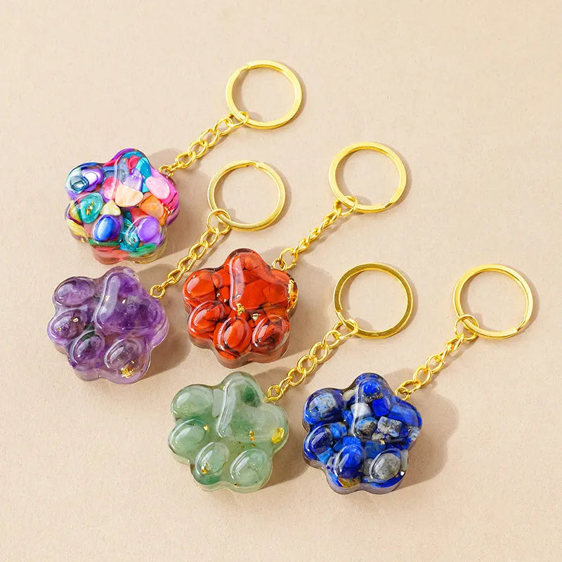 Small natural crystal cat's paw keychain pendant on a metal ring.
