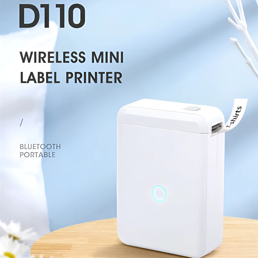 White D110 Bluetooth thermal label printer on desk with label tape showing 12mm print width