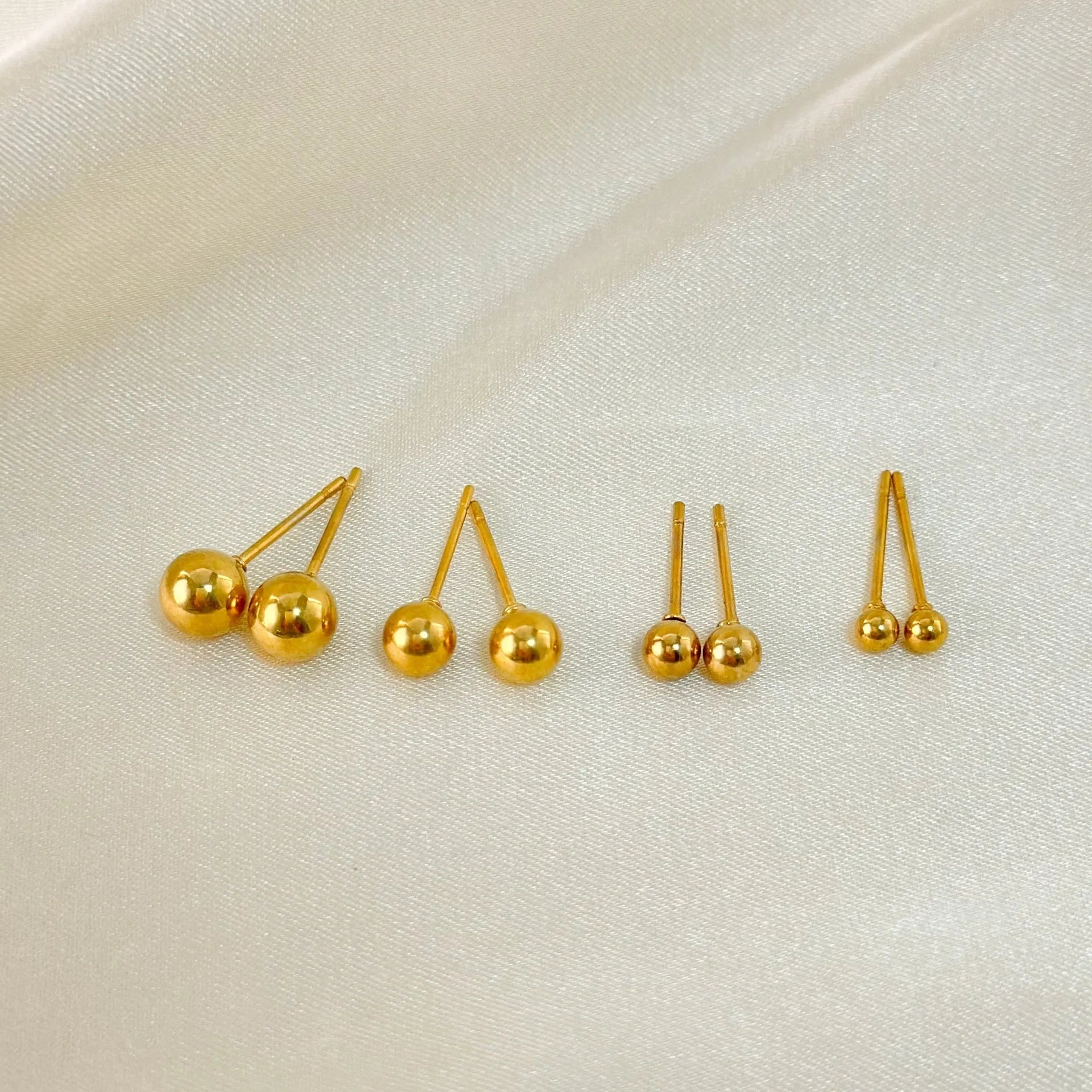 Titanium steel ball stud earrings in gold or silver finish, available in 3mm to 6mm sizes