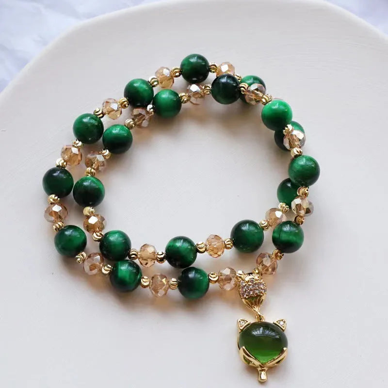 Handmade Vanves Stone Tigereye bracelet on wrist, showing single and double chain options with fox and leather charms.