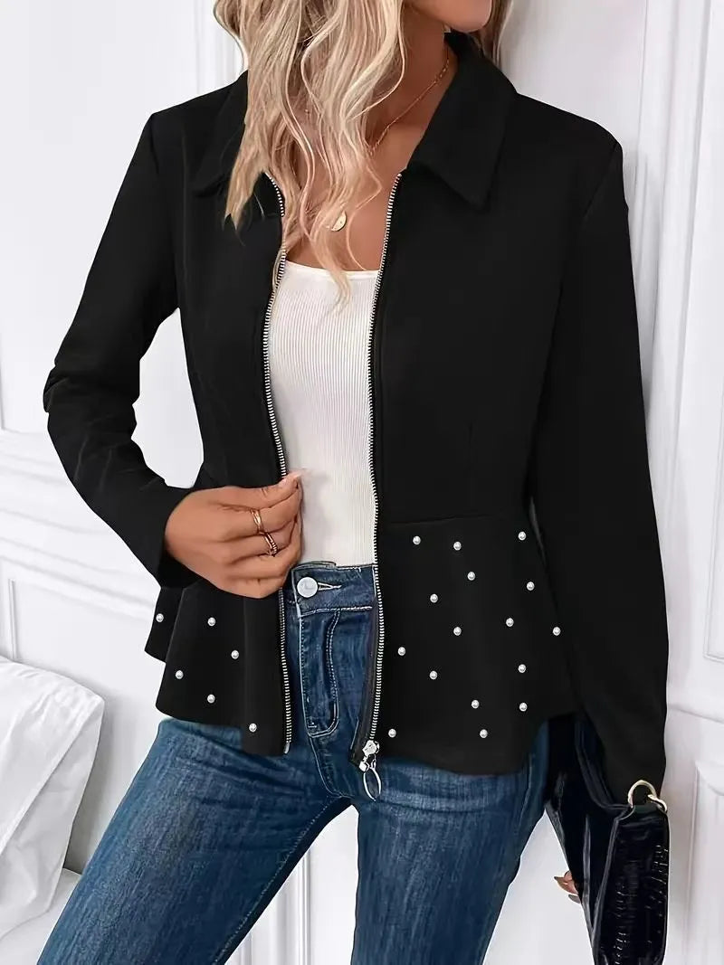 Women's loose fit black coat with a beaded zipper and ruffled hem detail on mannequin.