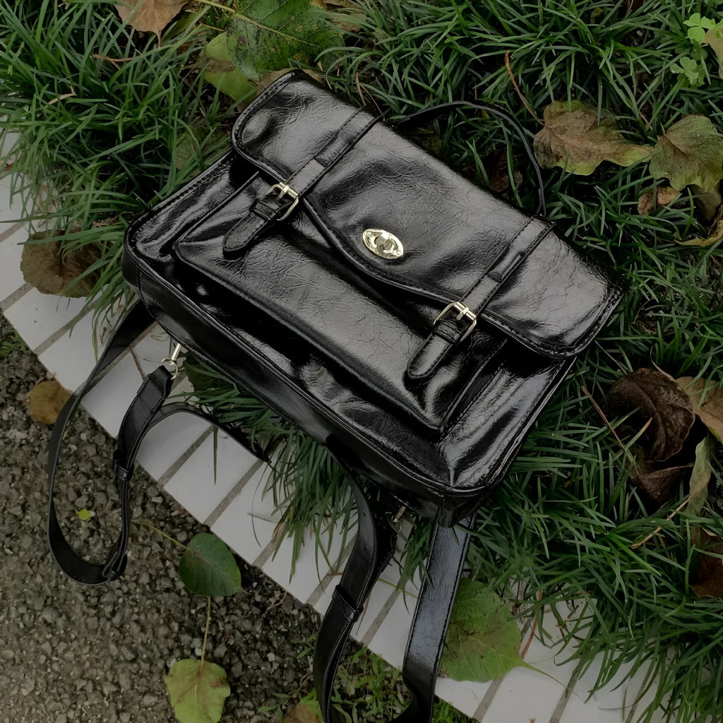 Black college style messenger bag made from PU with an oil wax leather look.