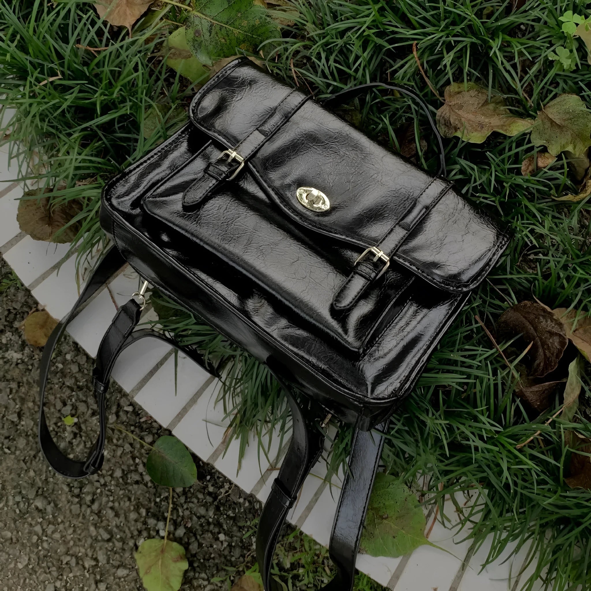 Black college style messenger bag made from PU with an oil wax leather look.