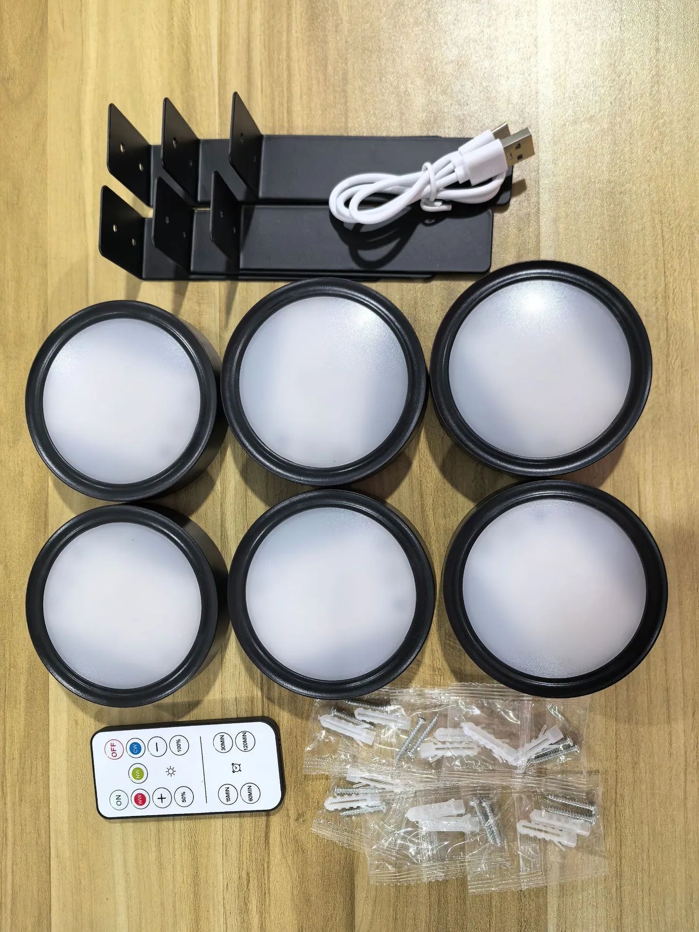 Wireless LED painting lamp with a magnetic mounting belt and remote control in black finish.
