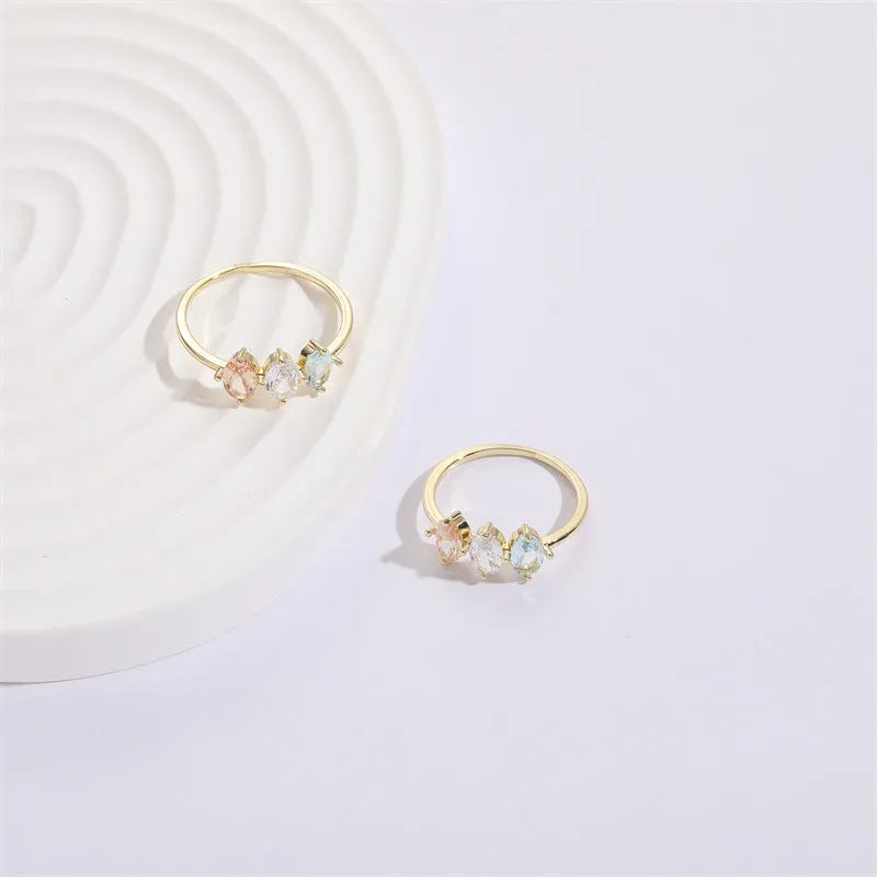 Geometric triangle design women's ring with horse eye motifs and tricolor zircon stones in 14k gold colour