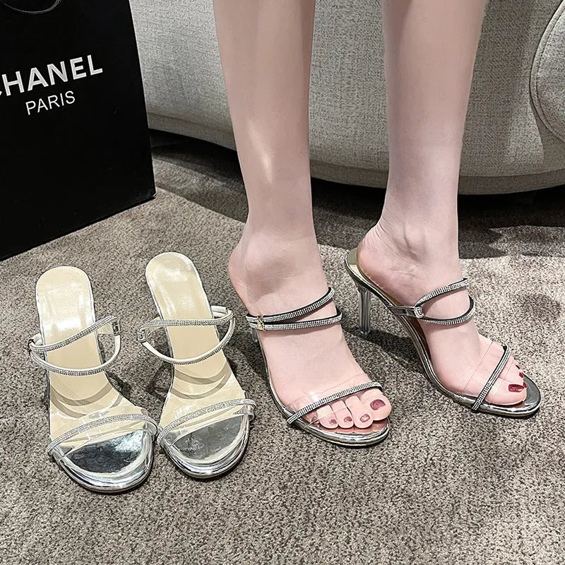Women's black rhinestone stiletto heel sandals with round toe and PU upper on a white background