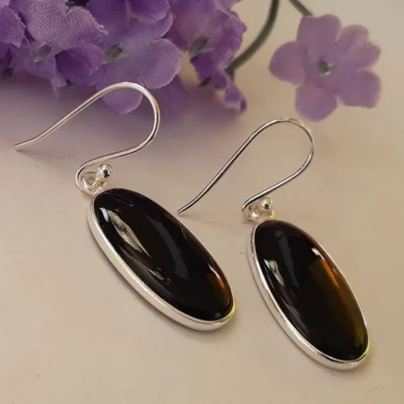 Black agate oval pendant earrings with geometric silver-toned frames and drop earring design
