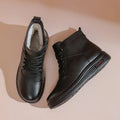Mother cowhide leather ankle boots with wool lining, platform heel, and side zipper in black