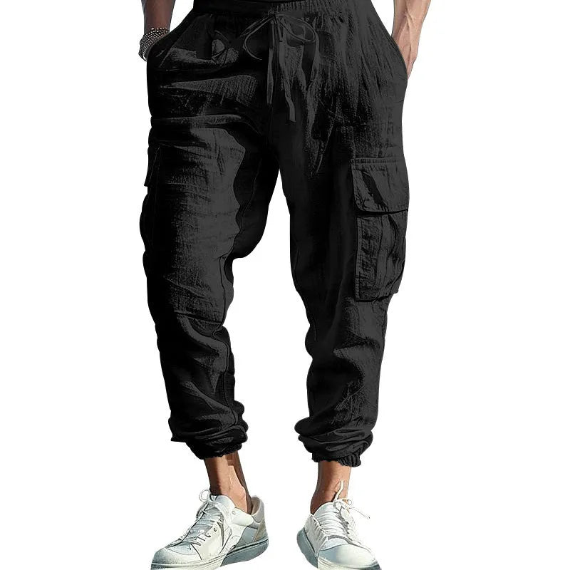 Men's loose-fit linen trousers in Army Green with ankle-tied cuffs and multiple pockets.