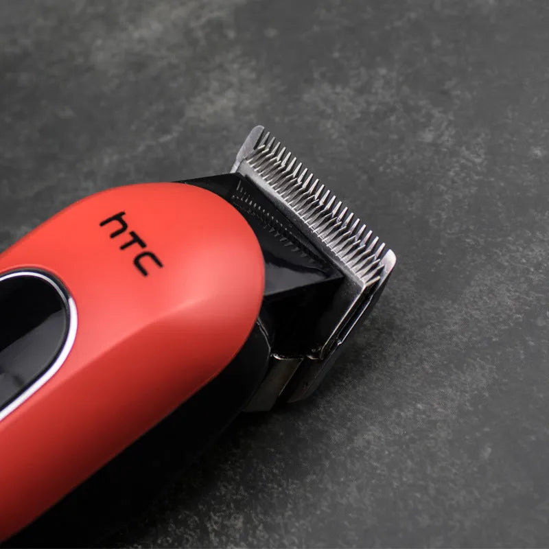 A black wireless hair clipper with four plastic limiting combs placed on a white background.