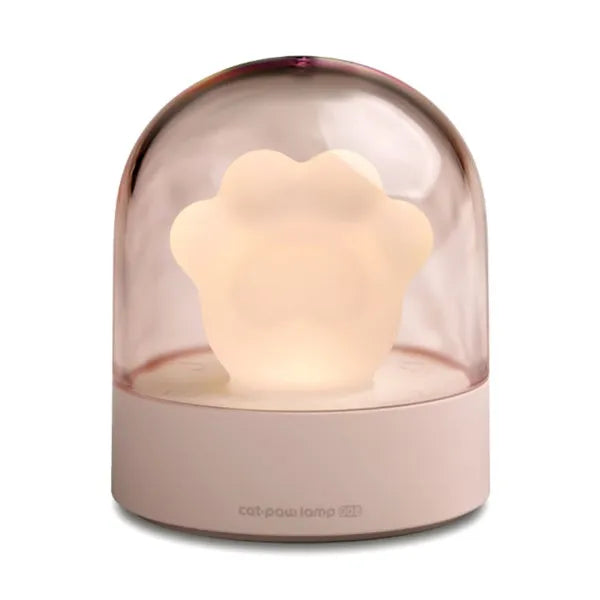 Grey or pink cat paw shaped USB rechargeable night light and music box on a desktop.