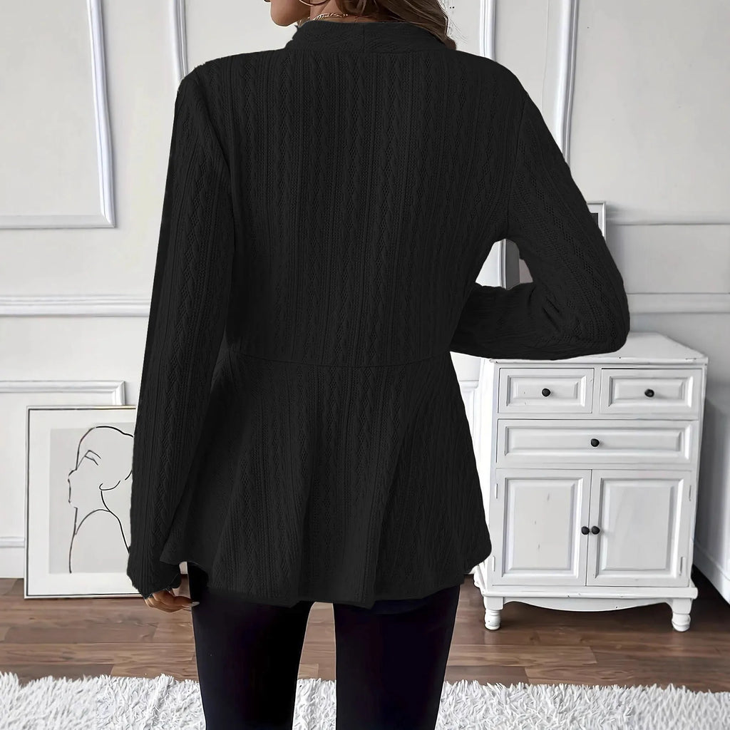 Women's apricot Jacquard knitted cardigan with a single button and long sleeves, laid flat.