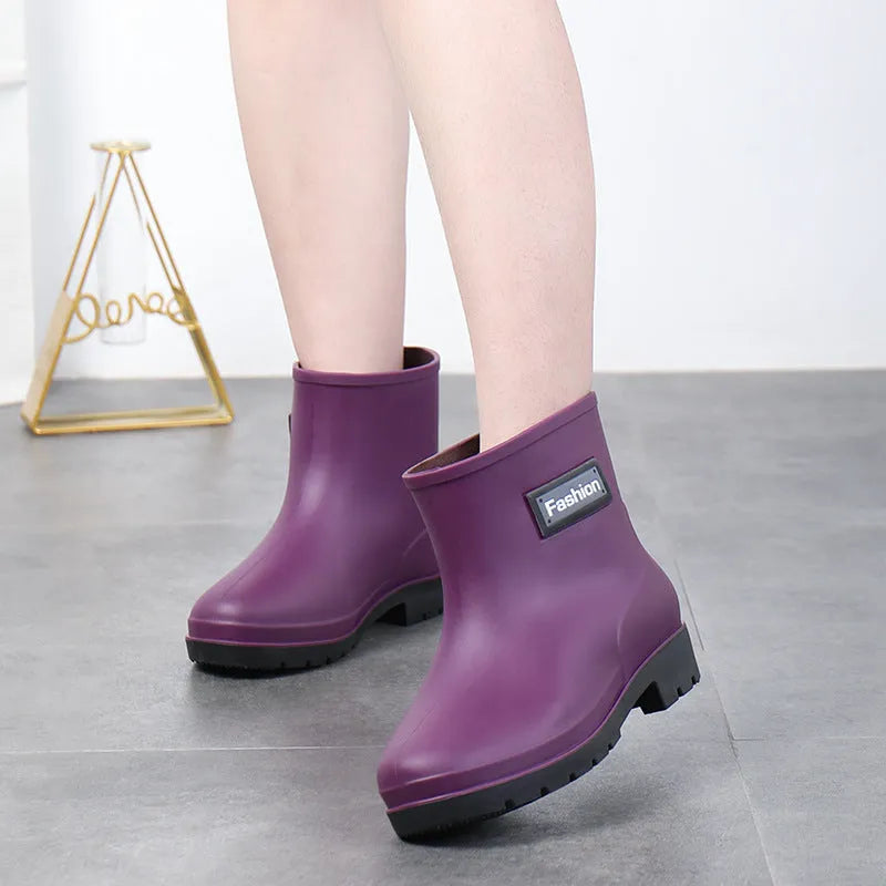 Women's mid-calf PVC rain boots in black with low heel design