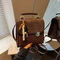 Small square PU leather messenger backpack for women with texture finish in black colour