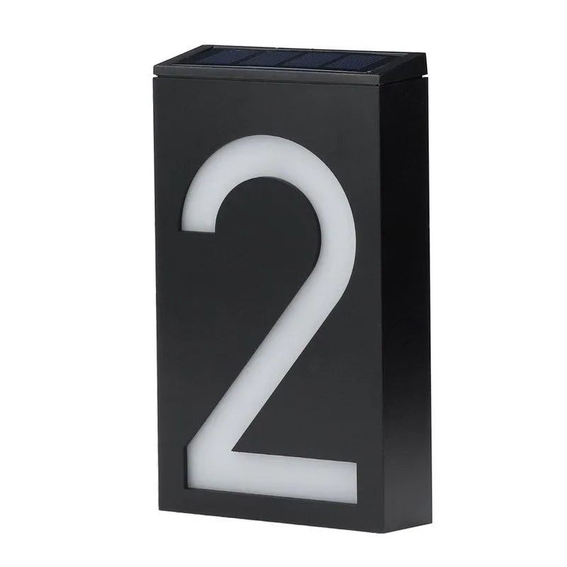 Solar powered outdoor house number light with white LEDs and wall mount.