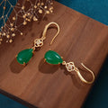 Gold-plated drop agate earrings on display showing alloy base and stone pendant