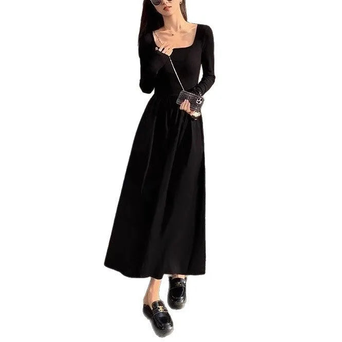 Women's black knitted dress with square collar, long sleeves, elastic waist, and A-line floor-length skirt