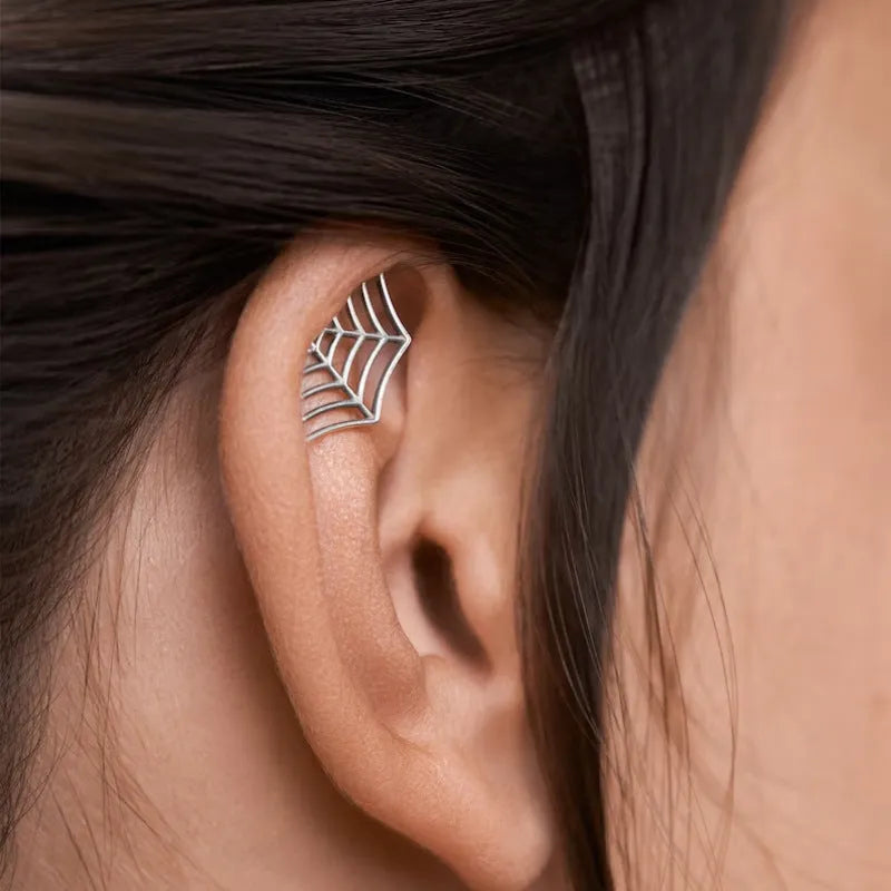 Spider web design stud earrings in gold and silver metal with geometric mesh pattern