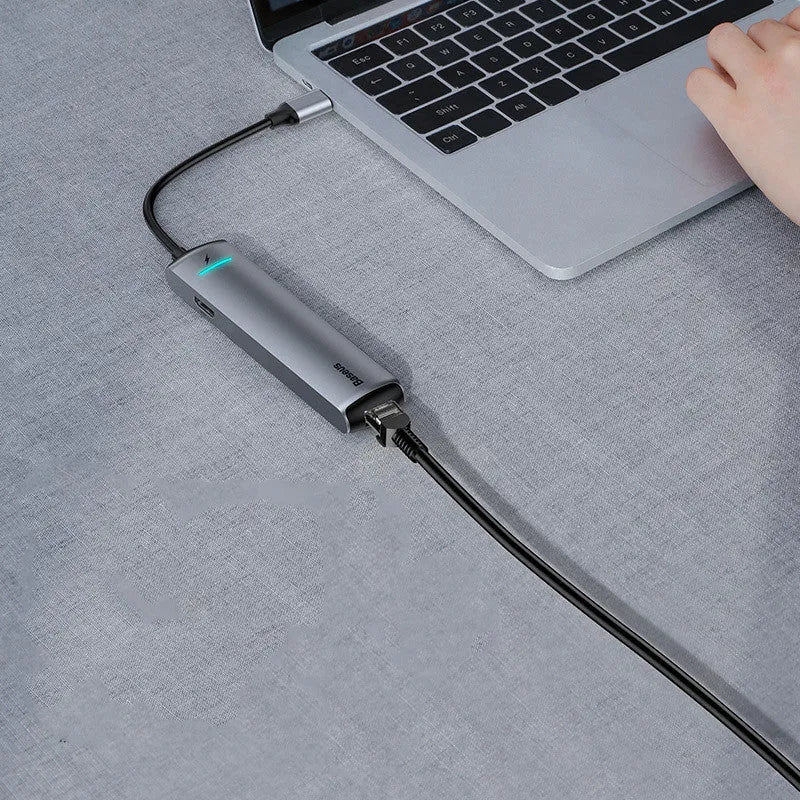 Mechanical Eye Type-C Docking Station in dark grey, compatible with MacBook and iPhone, on a desk