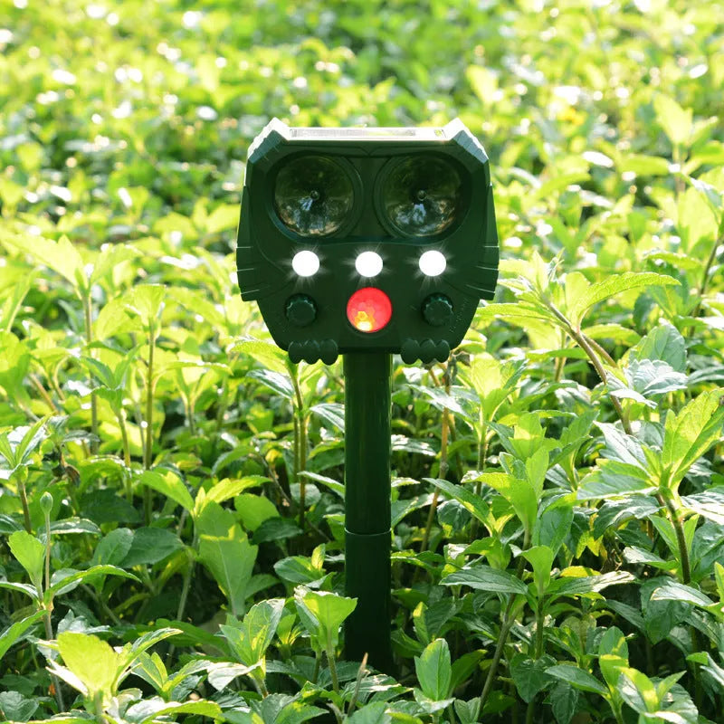 Green solar-powered ultrasonic dog repeller unit for outdoor garden protection
