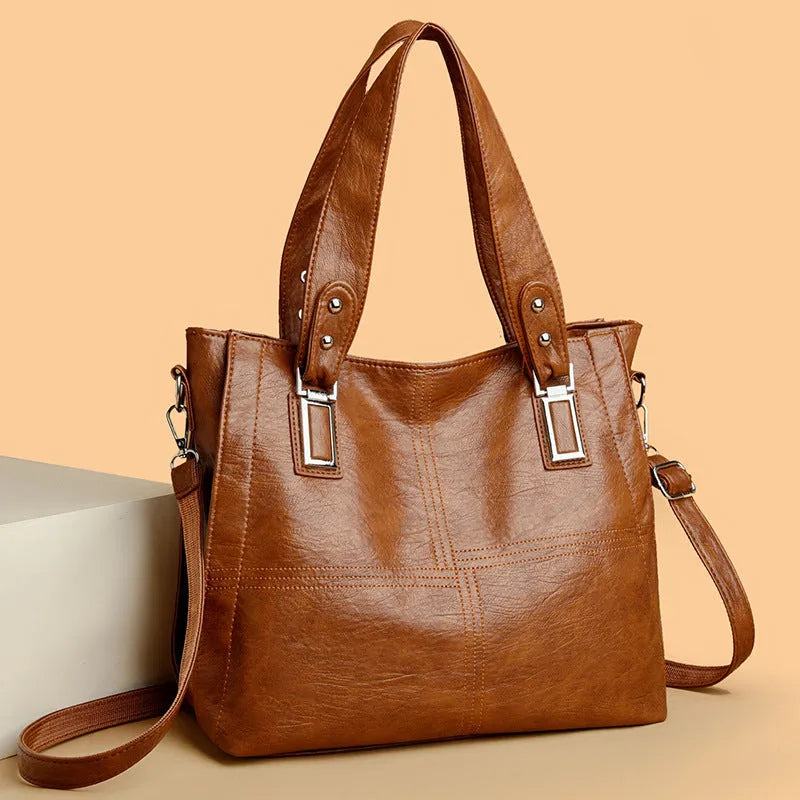 Women's soft PU handbag in horizontal square shape with sewing thread detail and single shoulder strap.