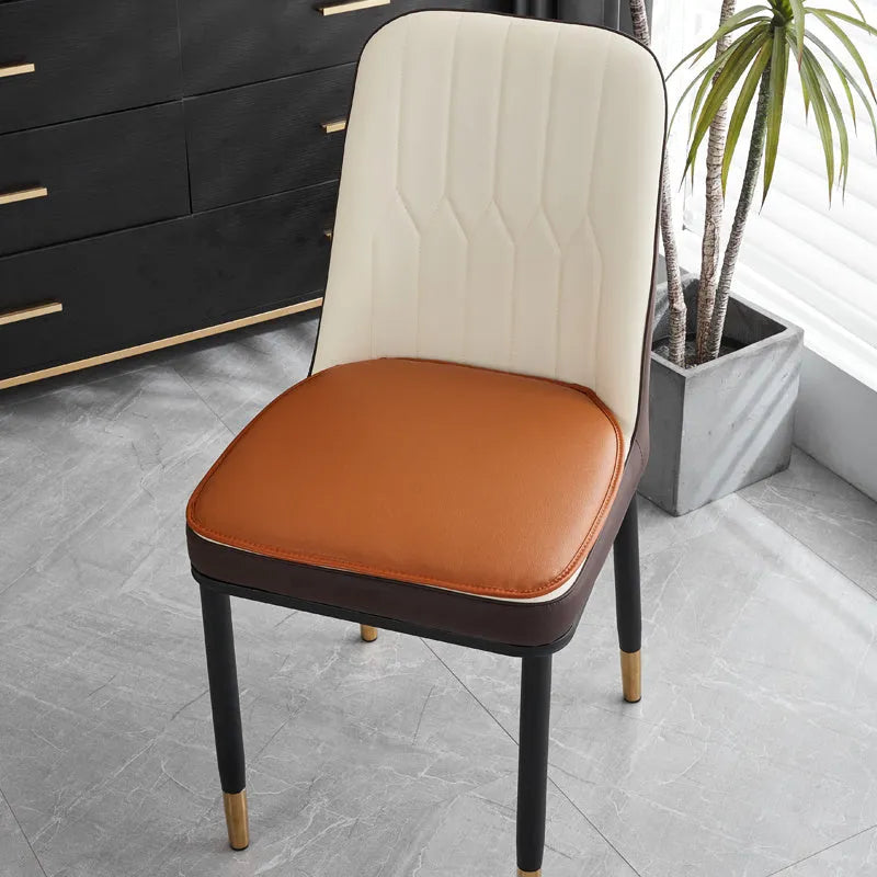 Leather horseshoe-shaped seat cushion in beige colour showing curved design and non-slip underside