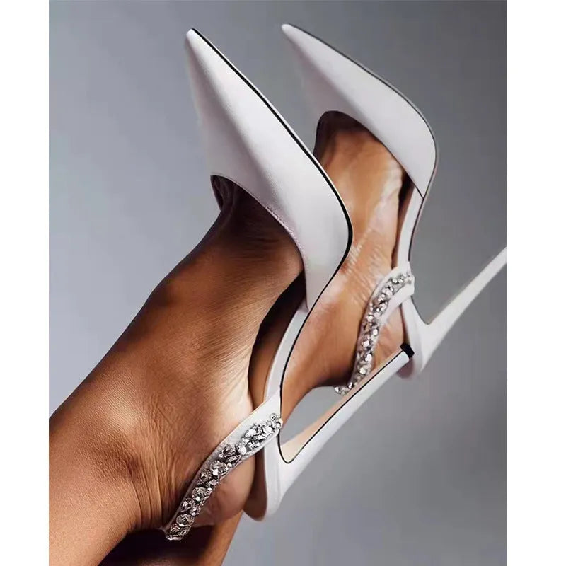 Women's patent leather high heel sandals with pointed toe, clear ankle strap, and rhinestone details.
