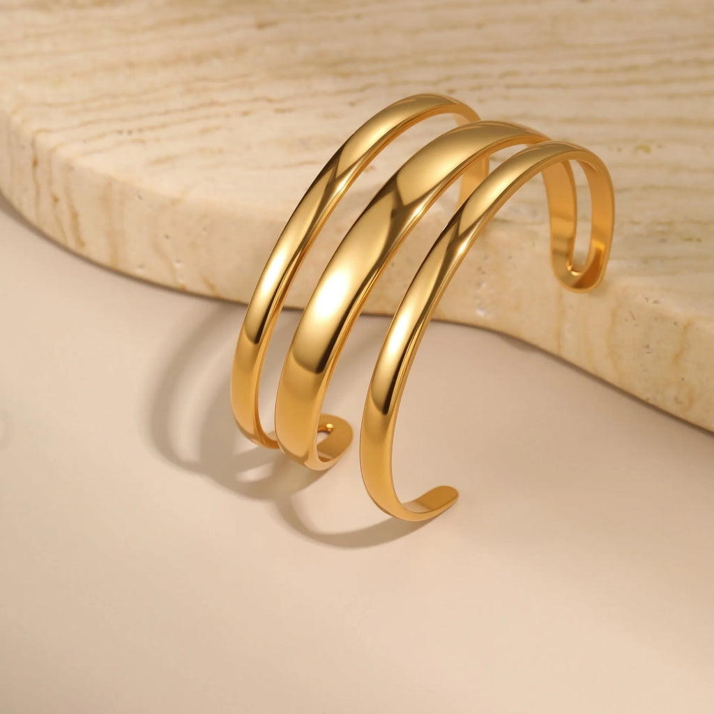 Gold and steel colour geometric line design stainless steel bracelet for women with simple opening clasp.