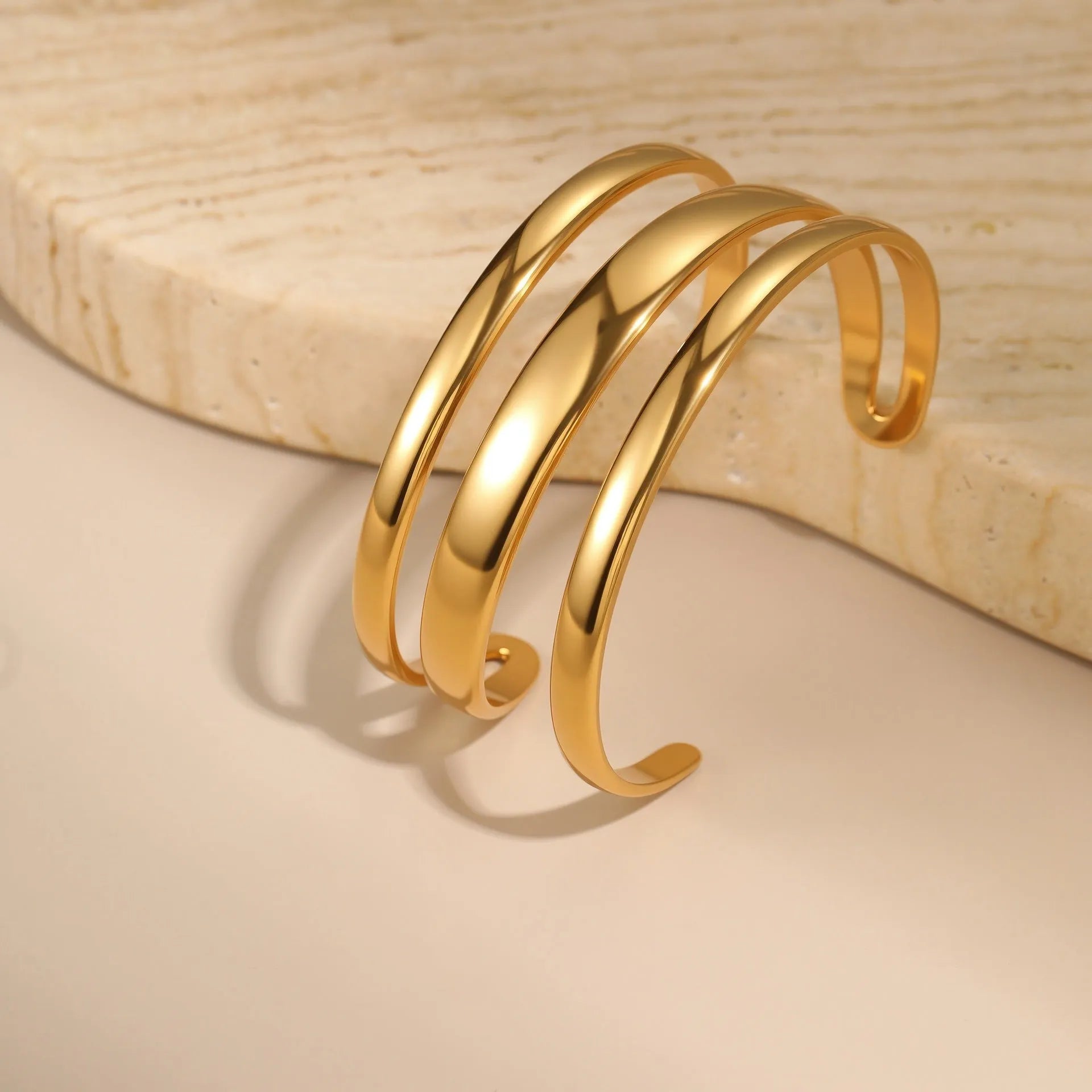 Gold and steel colour geometric line design stainless steel bracelet for women with simple opening clasp.