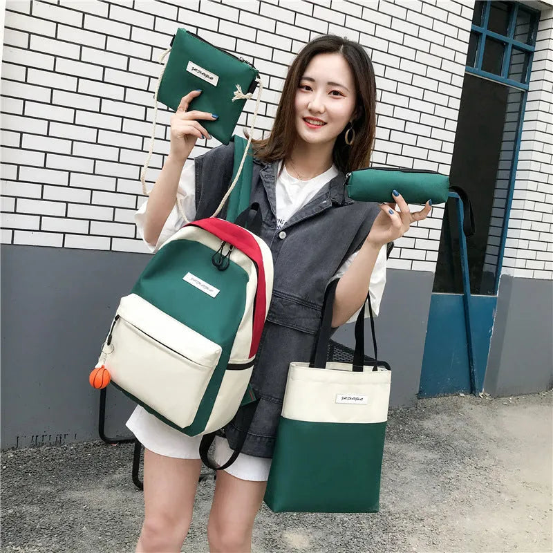 Four medium canvas backpacks in black, green, red, and white with zipper closure and air cushion straps