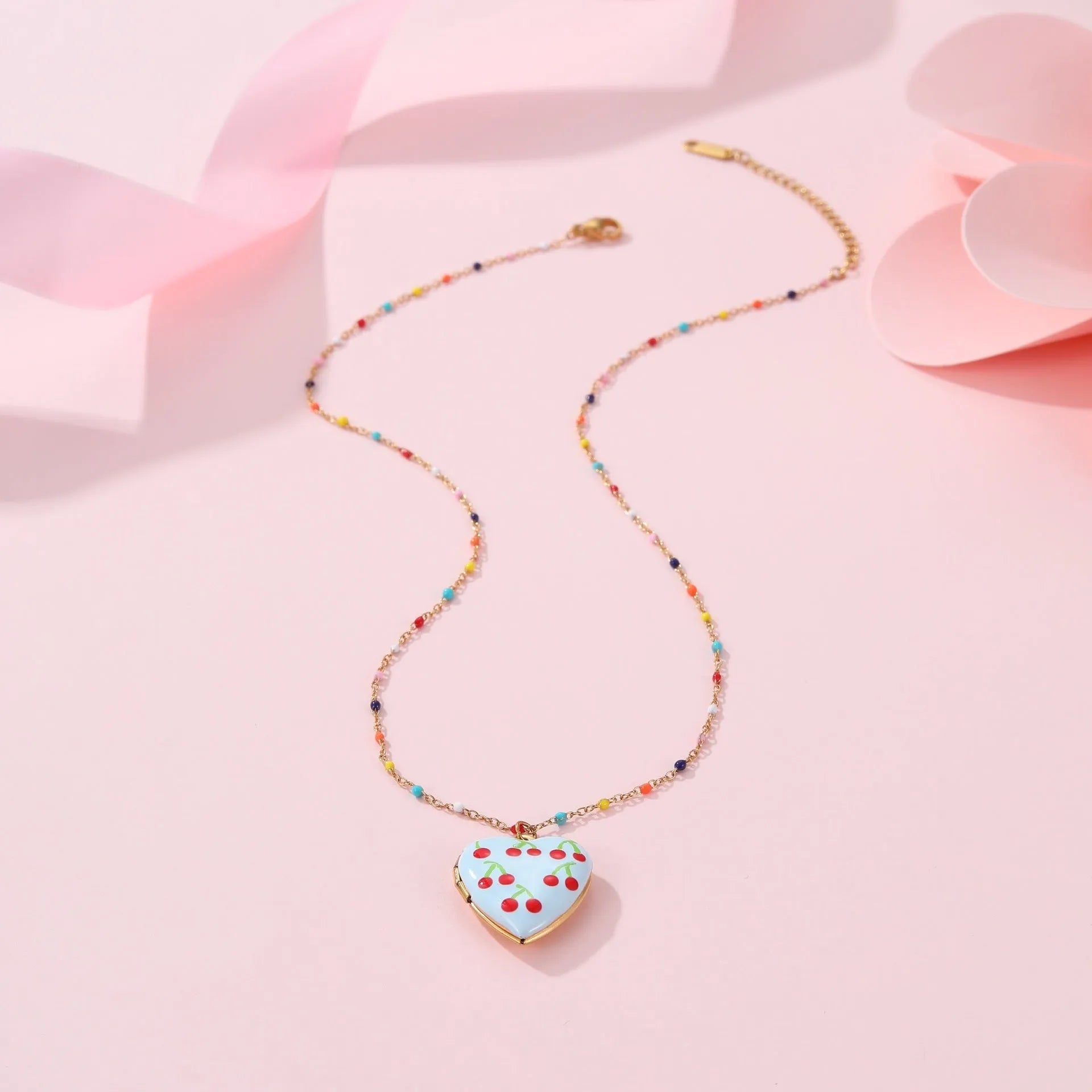 Gold-plated stainless steel necklace with heart-shaped fruit pendant on an adjustable chain.