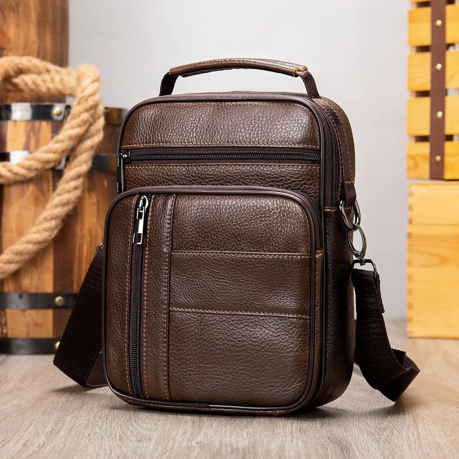 Men's black genuine leather vintage shoulder bag showing zipper opening and soft handle.