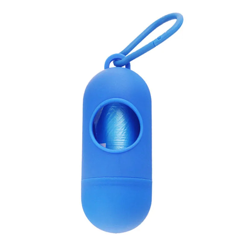 Black plastic dog poop bag holder with a metal side hook and Velcro strap, showing compact size.