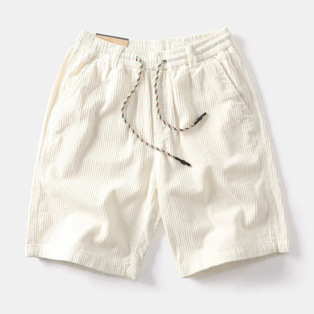 Men's khaki retro-style cargo shorts with a straight leg on a summer streetwear background.