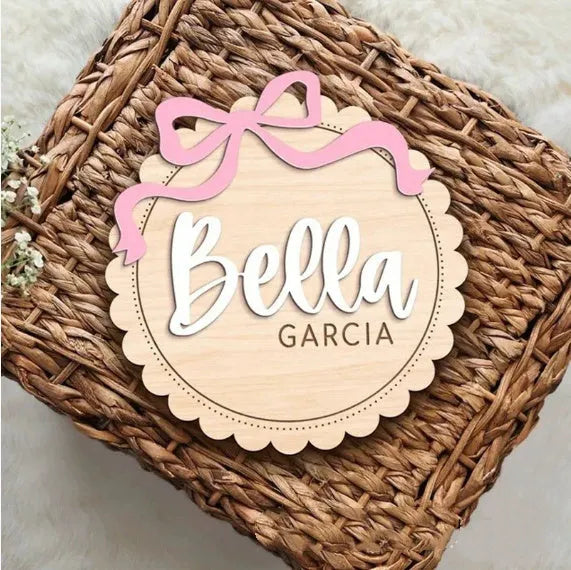 Customised square wooden baby room ornament with a personal name, shown in two size options.