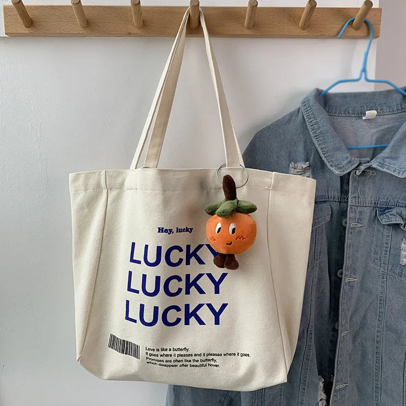 Natural colour canvas tote bag with metal magnet buckle closure and small front pocket, 32x31.5x10cm