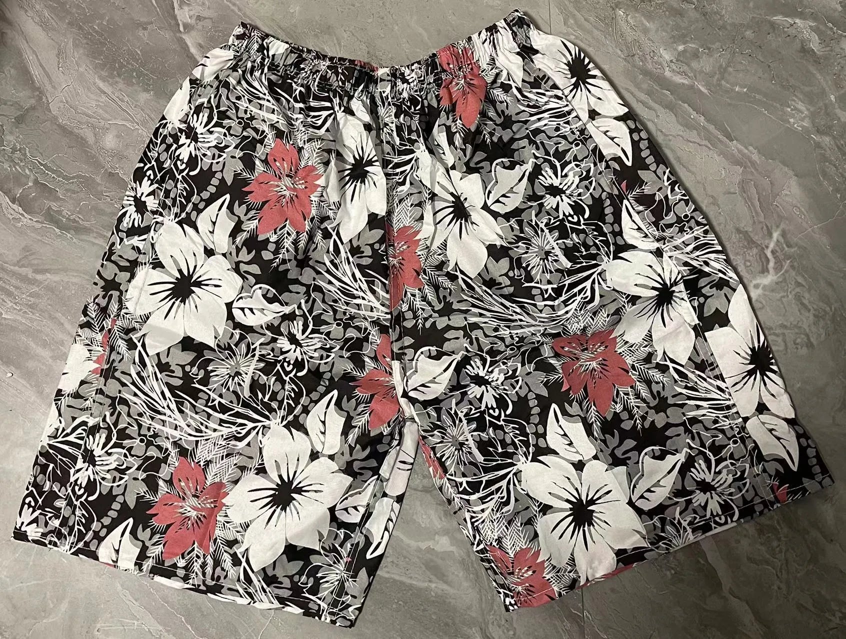 Men's floral print five-point swimming trunks in polyester, showing one of 24 available colour patterns.