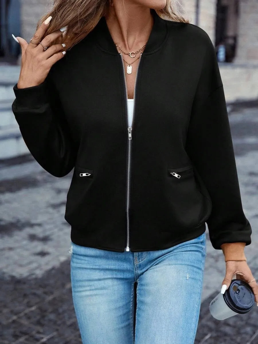 Black women's casual zip-up jacket with long sleeves and faux pockets on a hanger.