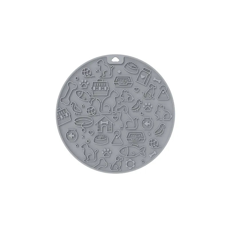 A blue silicone pet licking mat with a suction cup base on a kitchen floor.