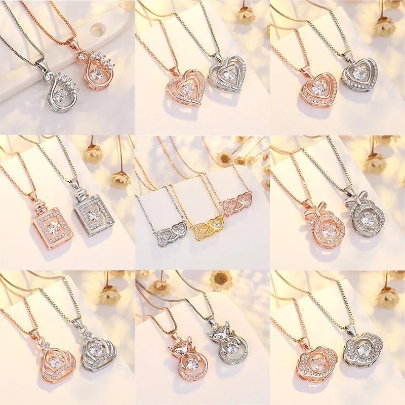 Silver heart pendant necklace with small crown and bow charms on a delicate chain.