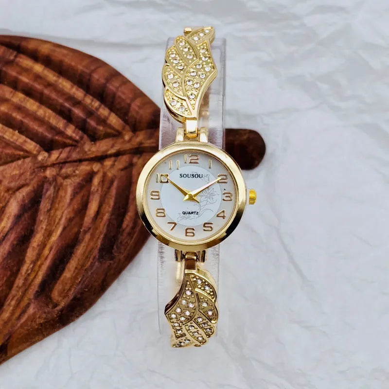 Women's stainless steel watch with round dial on wrist, showing Vachette clasp.