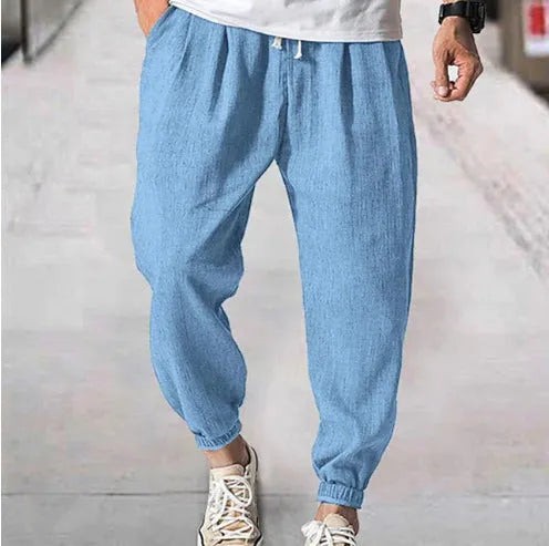 Men's cotton ankle banded trousers in light green colour showing loose fit and summer casual styling
