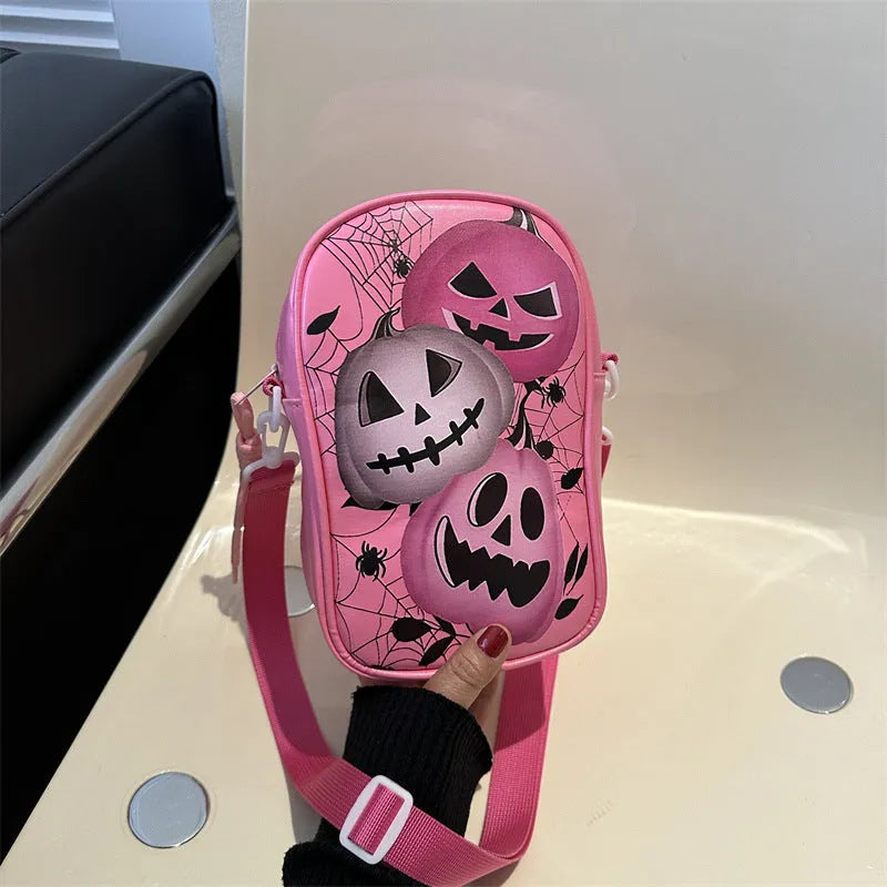 Black mini crossbody phone bag with Halloween graffiti print showing pumpkins, ghosts and bats