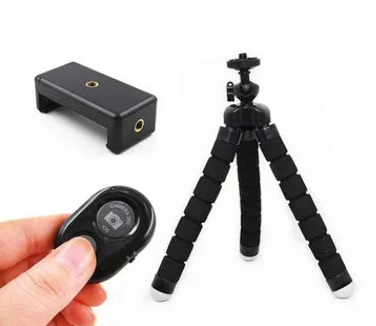 Black flexible octopus tripod with wrapped legs next to a smartphone, showing its 18cm size and universal screw mount.